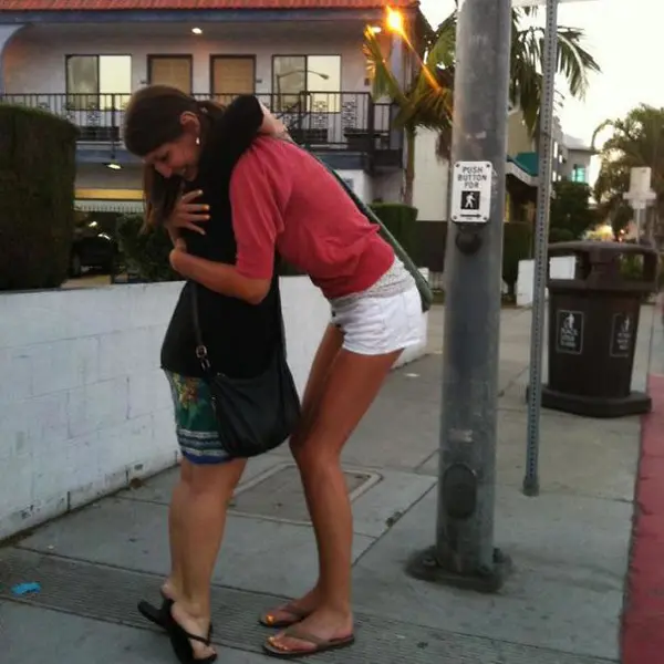 tall people struggles hugging friend