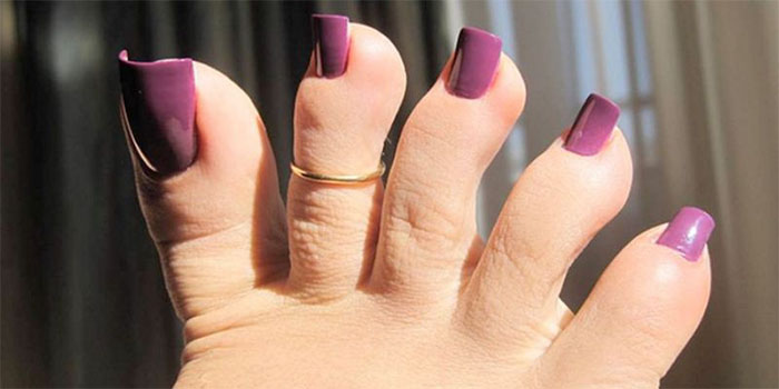 Long fake toenails painted purple