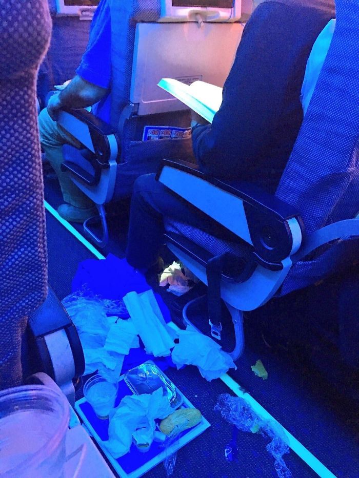 people being jerks food garbage airplane aisle