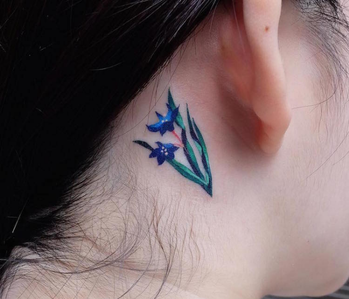 blue flower at neck best floral tattoo artists