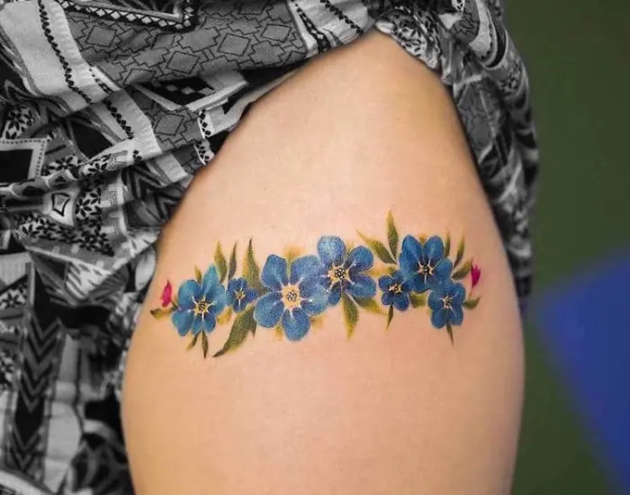 blue flowers upper arm best floral tattoo artists