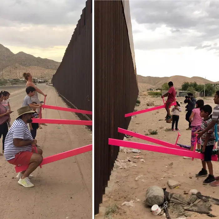 children and adults playing seesaw in the us mexican border