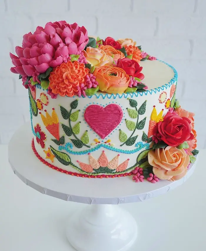 white cake with heart embroidered patterns in cakes leslie vigil