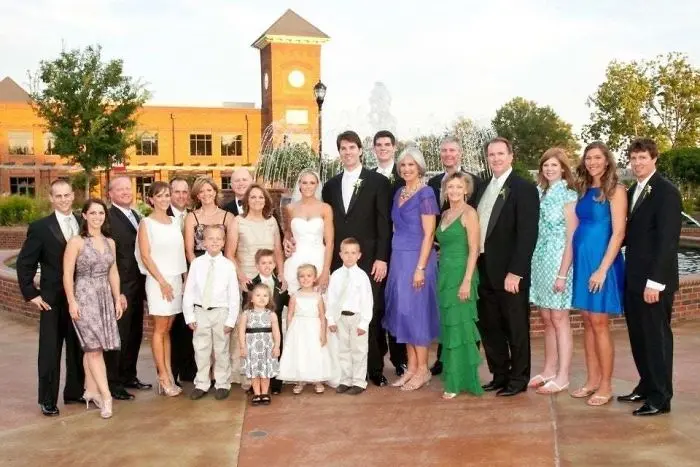 tall people with short people family wedding photo