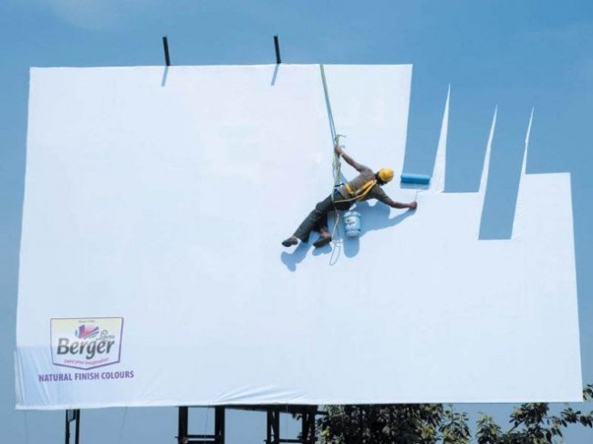 Berger Paints Advertisement Featuring a Man Painting the Billboard with Skyblue