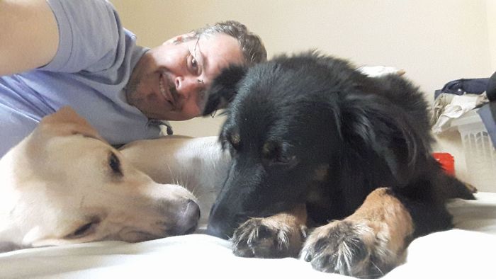 Father João Paulo Araujo Gomes Taking a Selfie with Two Stray Dogs