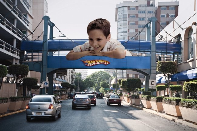 Hot Wheels Billboard Featuring a Boy Looking at Actual Road Traffic