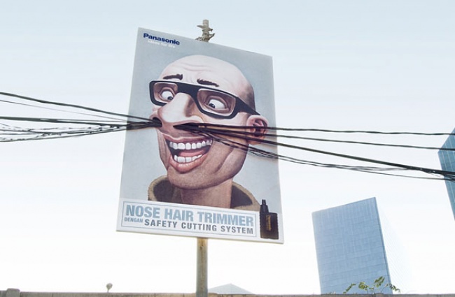 Panasonic Nose Hair Trimmer Billboard Featuring a Man with Cable Wires as Nose Hair