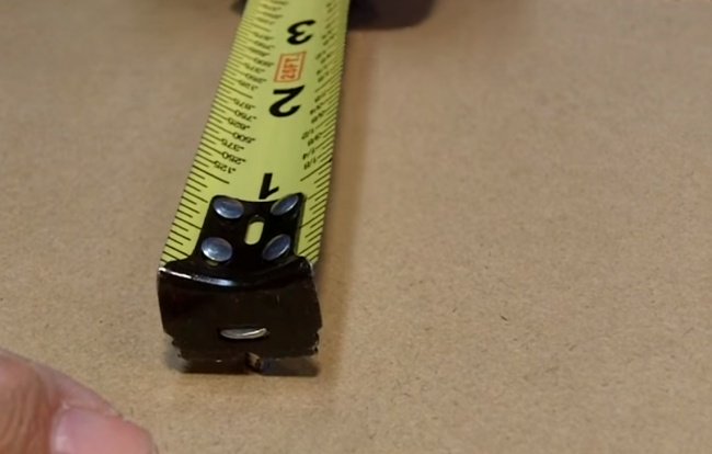 Tape Measure Hooked on to a Screw