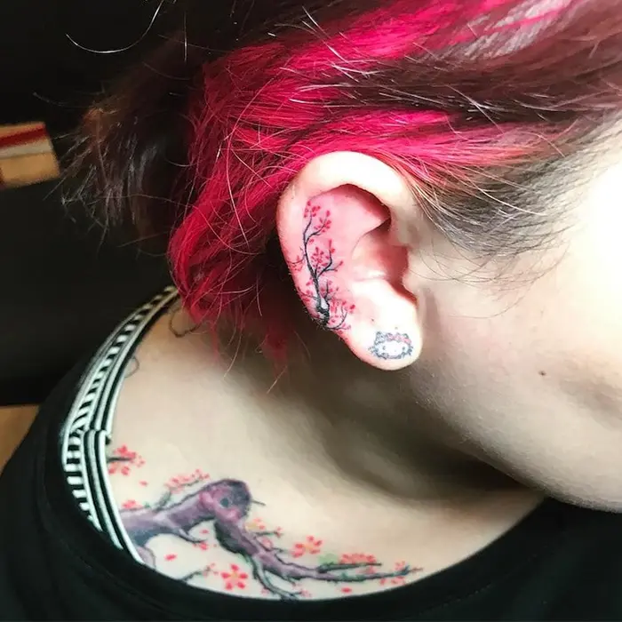 cherry blossom branch and hello kitty helix ear tattoo by phammaivnstyle