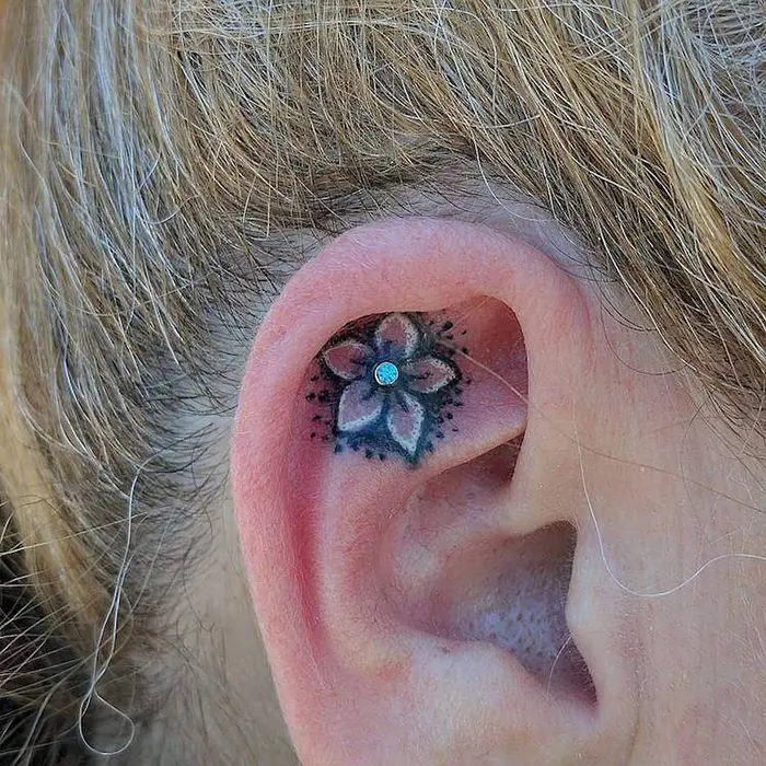 flower with piercing helix ear tattoo