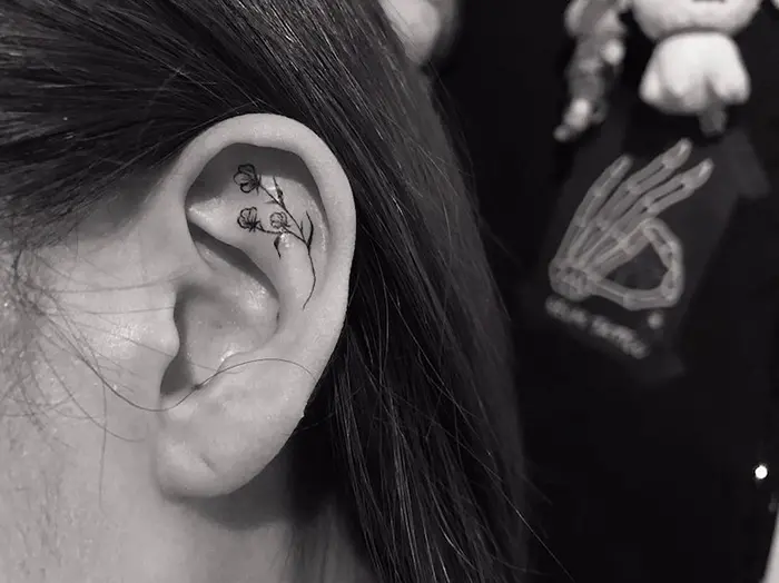 simple black flowers helix ear tattoo by tattoo geomi