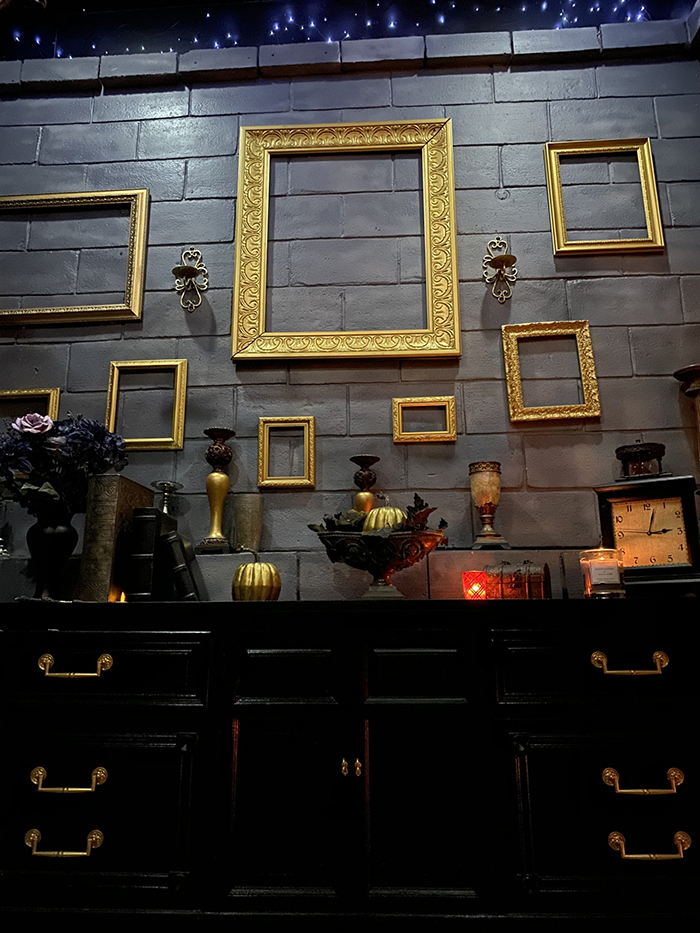 Black Cabinets and Gold Frames Hanging on the Wall