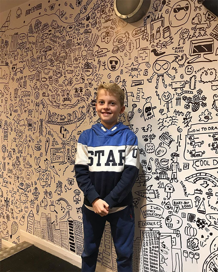 Joe Whale Posing with His Wall Doodles