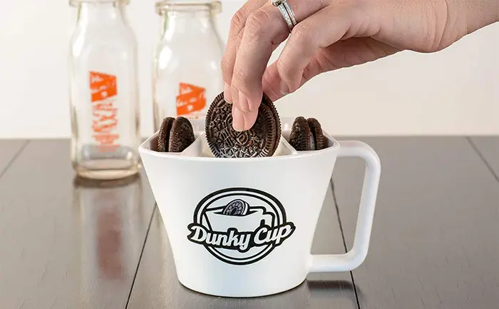 dunking cookies into hot milk mug