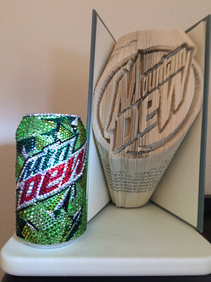 Glass Rhinestone Mountain Dew Can next to soda logo crafted with book