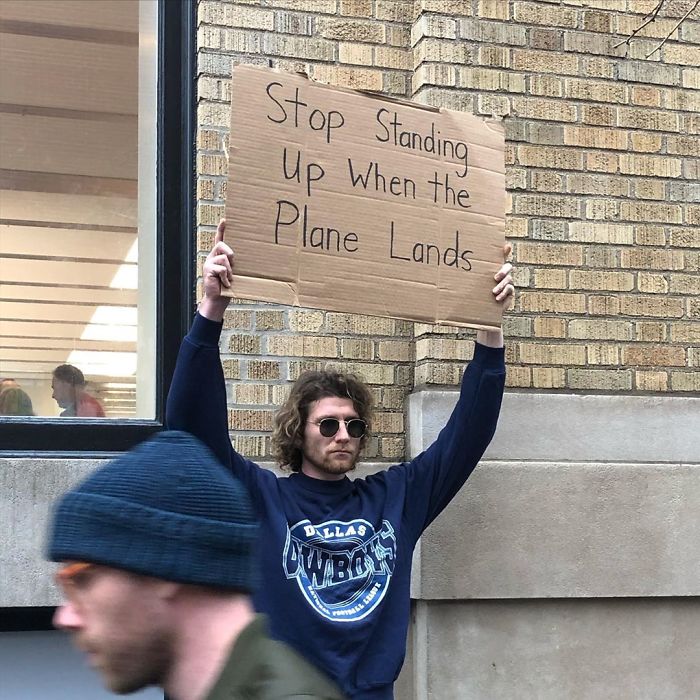 dude with sign plane landing