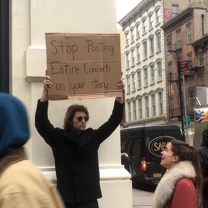 dude with sign posting concert
