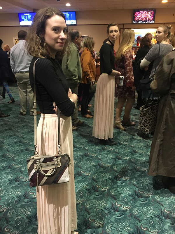 ladies wearing same black top and pale pink skirt