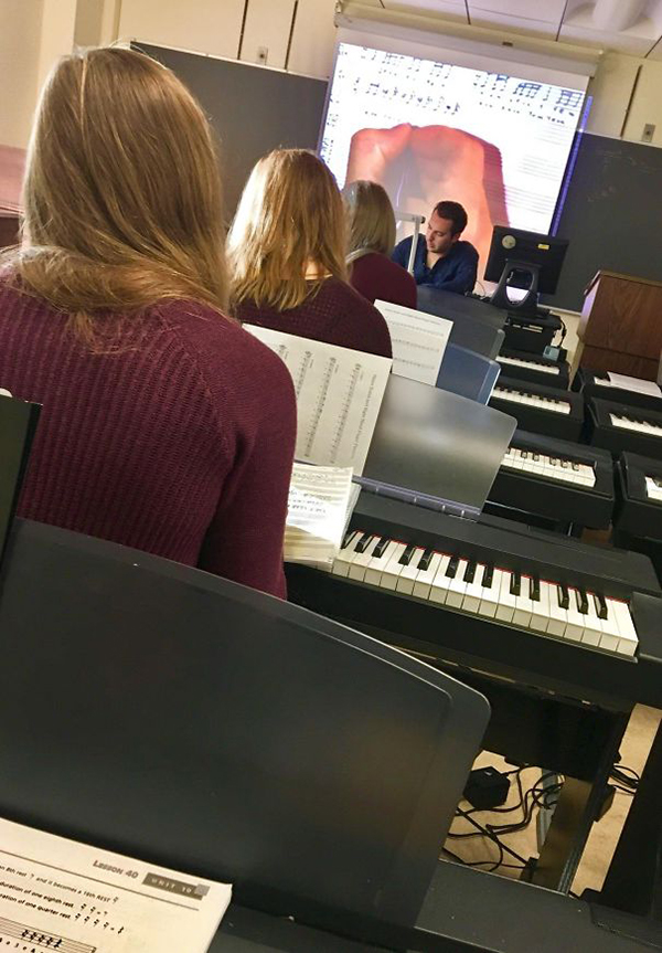 three girls in one row same color sweater same hair color