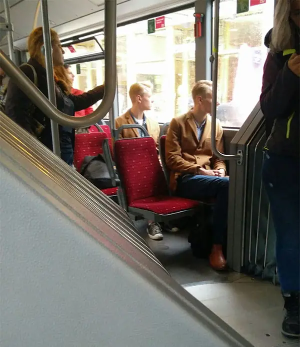 two blond males wearing similar coats