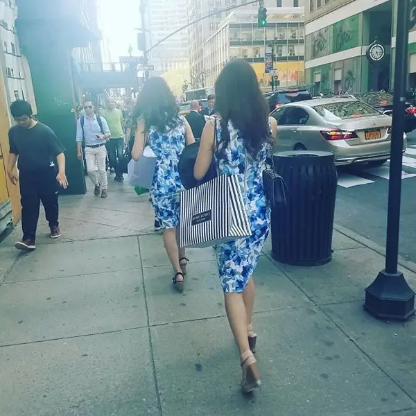 two ladies wearing a blue floral dress