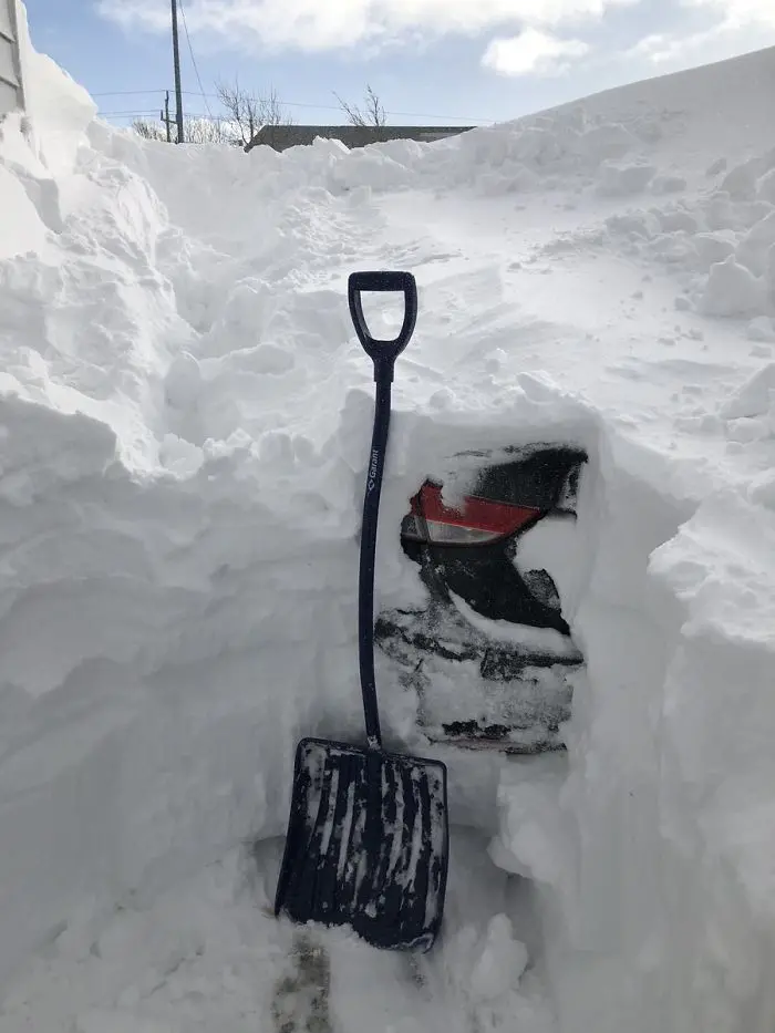 canada blizzard digging up buried car