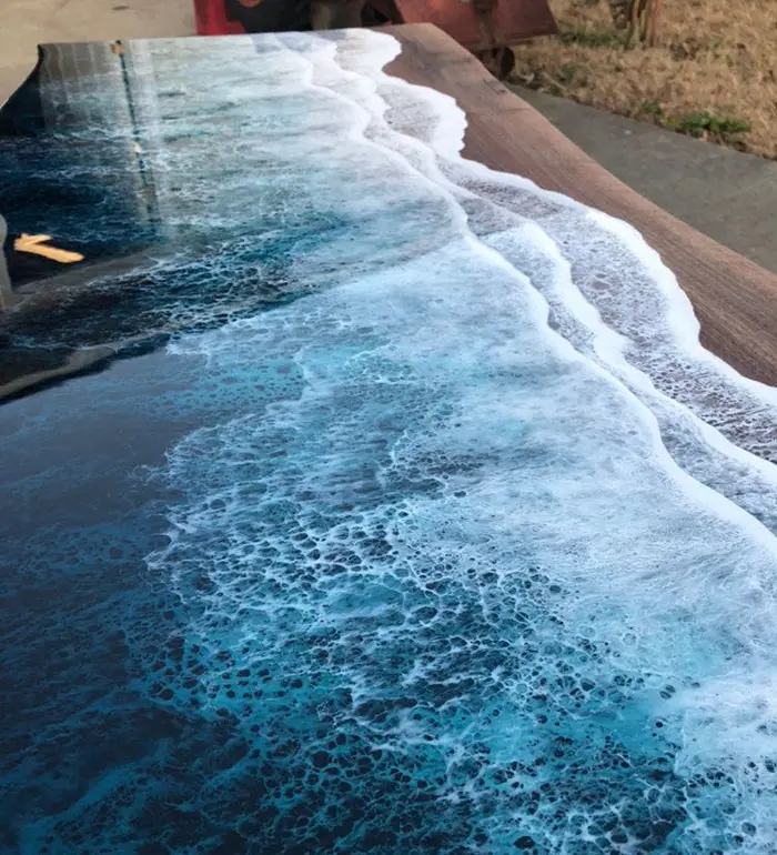 layered resin resembles ocean waves crashing on a beach