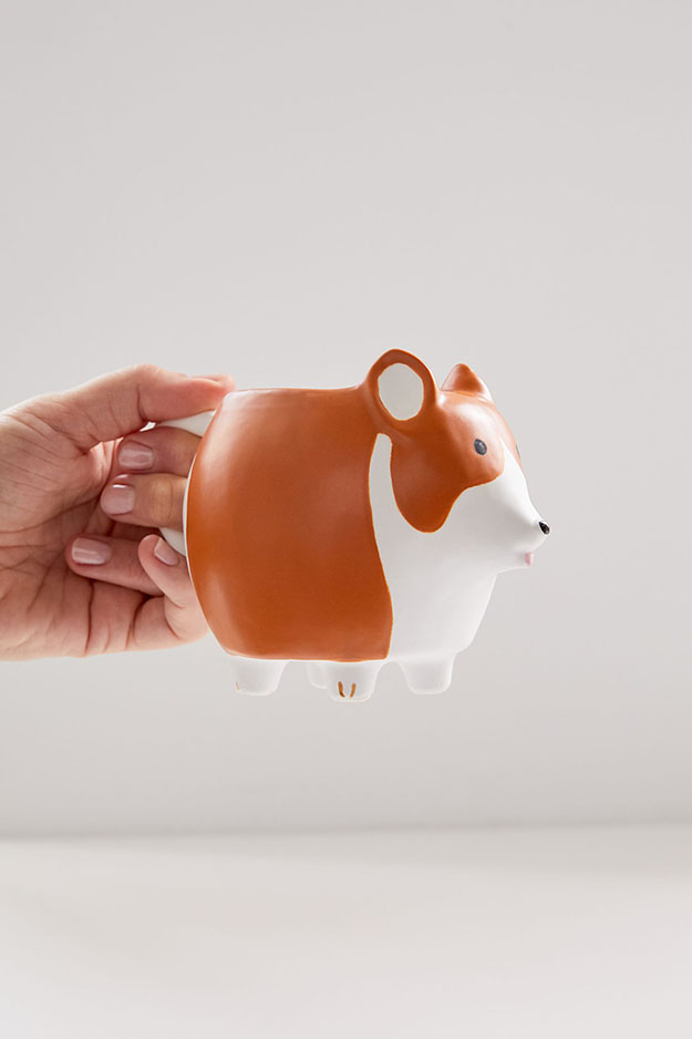 model holds the corgi dishware mug