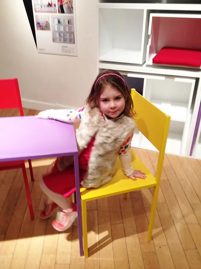 Girl Sitting on Yellow Chair