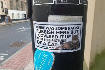 cat stickers cover up racist graffiti