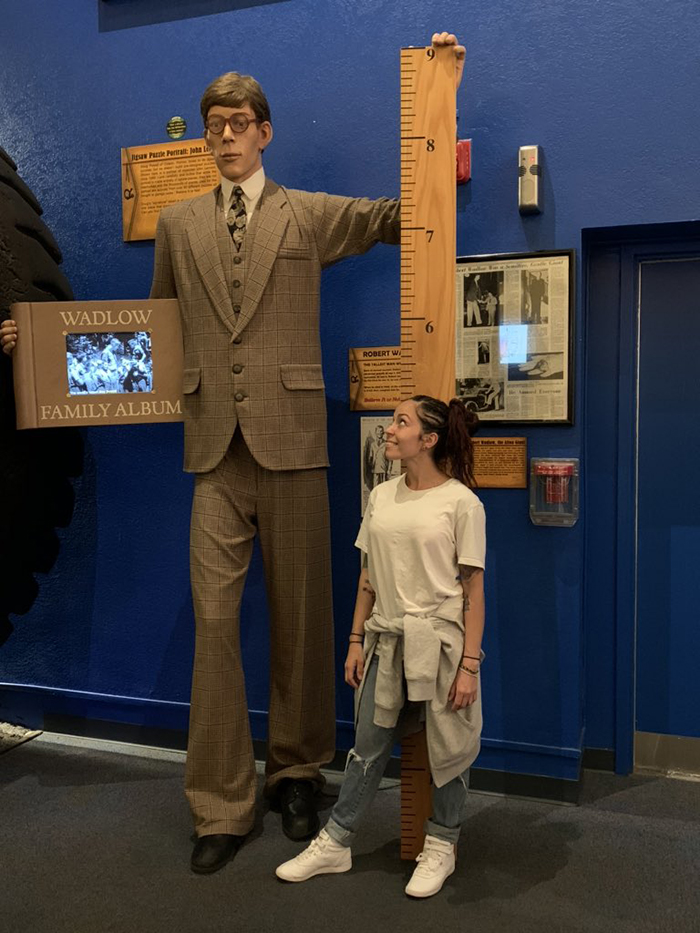 standing next to a giant wax figure
