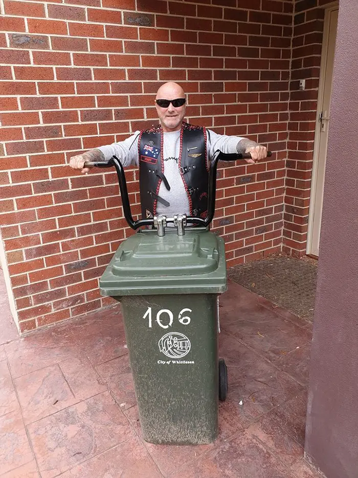 Biker Turning a Bin into a Motorcycle