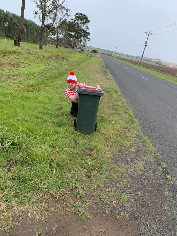 Bin Isolation Outing Man Dressed as Wally Hiding Behind a Bin