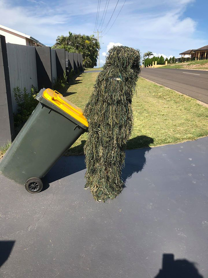 Bin Isolation Outing Person in Ghillie Suit Taking Bin Out