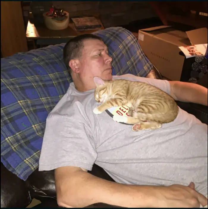 Cat Sleeping on Man's Chest