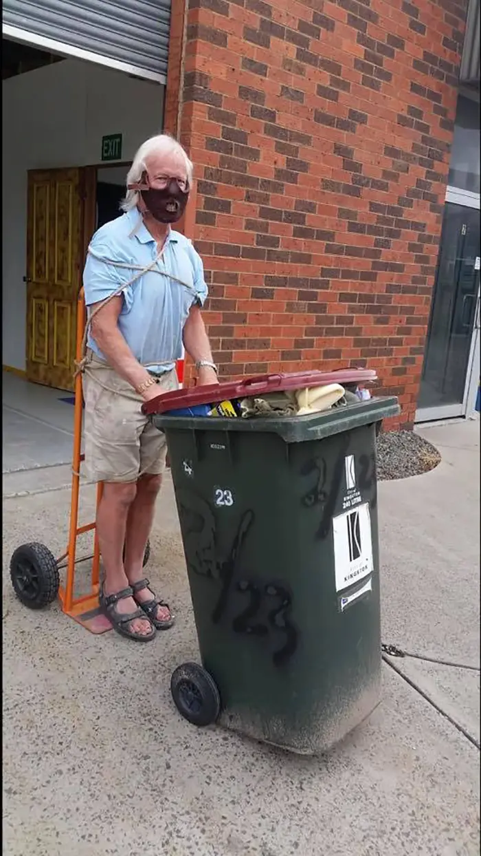 Man Dressed as Hannibal Lecter Taking Trash Out