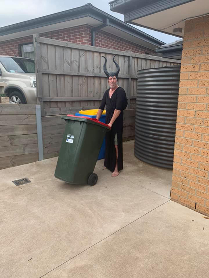 Man Dressed as Maleficent Taking Trash Out