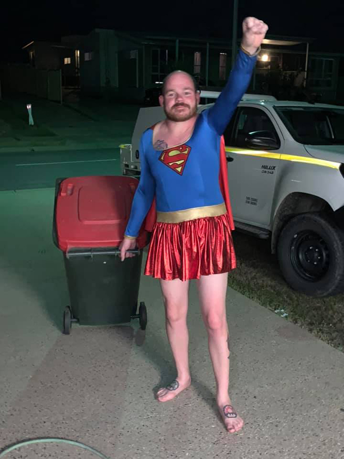 Man Dressed as Supergirl Taking Trash Out