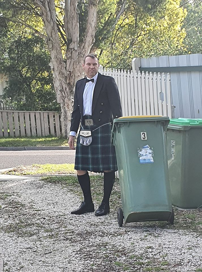 Man in Kilt Taking Trash Out