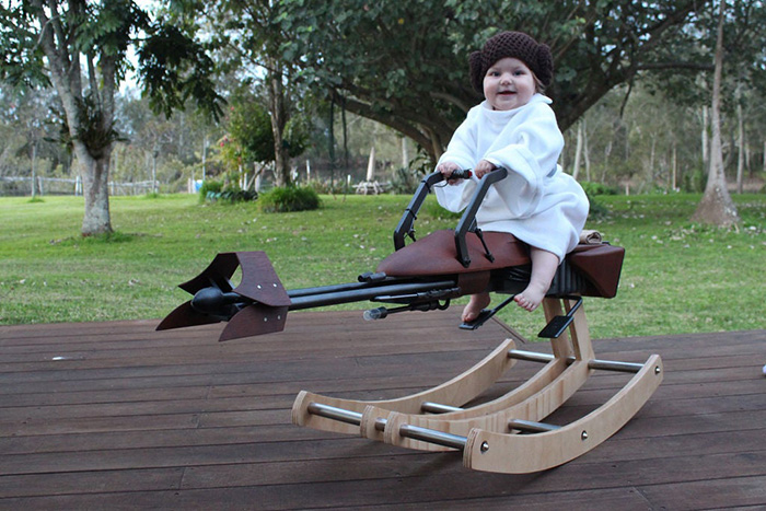 One-year-old Girl Sitting on Rocking Speeder Bike