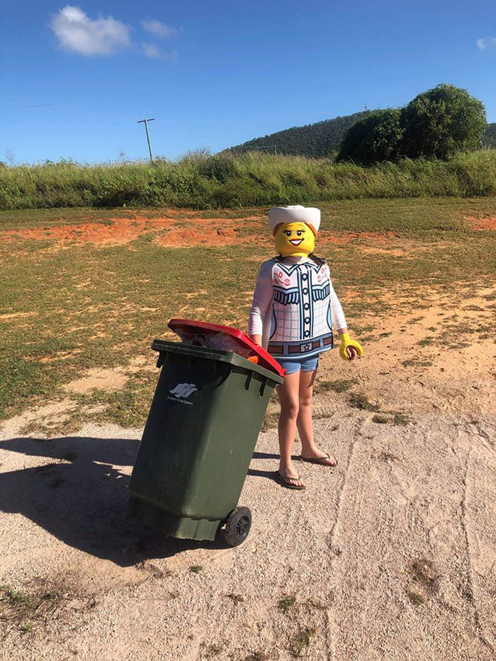 Person Dressed Like a LEGO Taking Trash Out