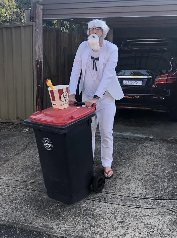 Person Dressed as Colonel Sanders Taking Trash Out