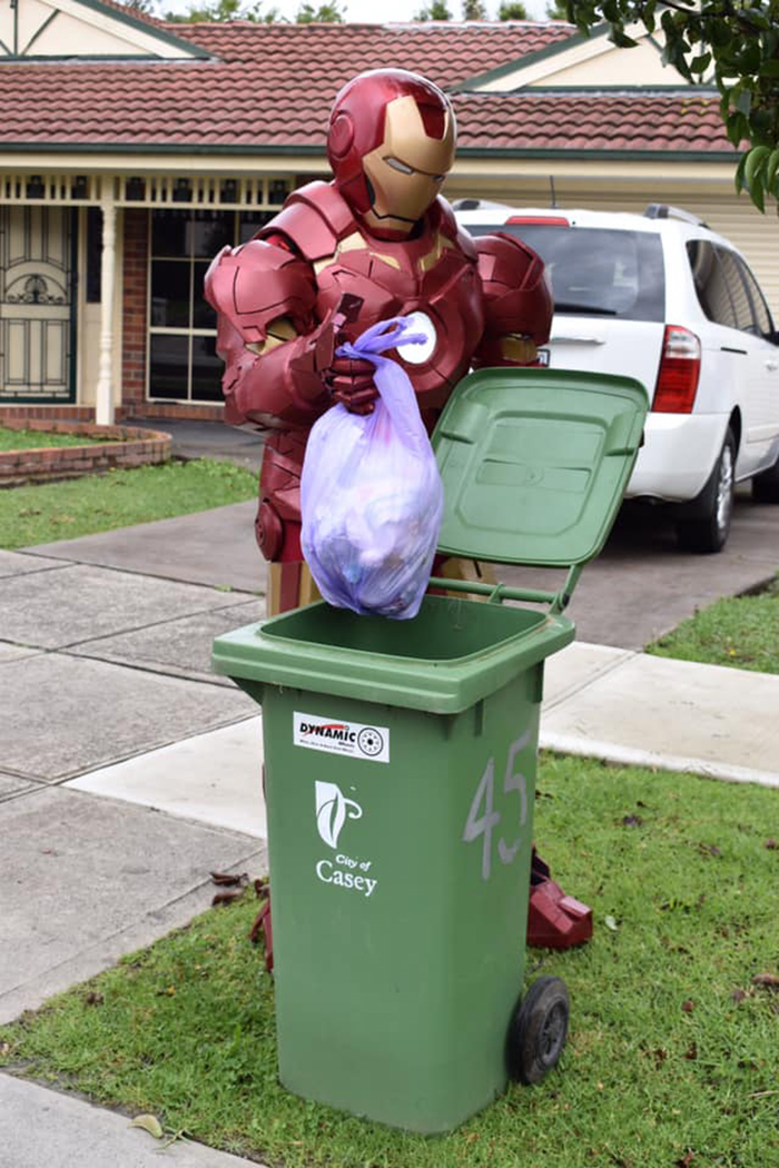 Person Dressed as Iron Man Taking Trash Out