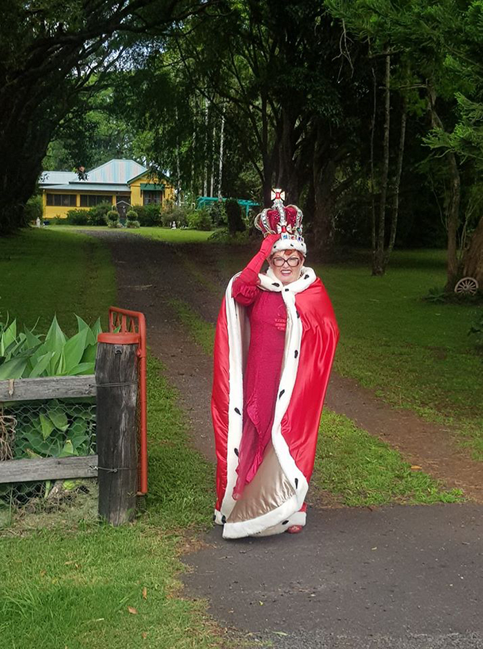 Woman Dressed as Queen Taking Trash Out