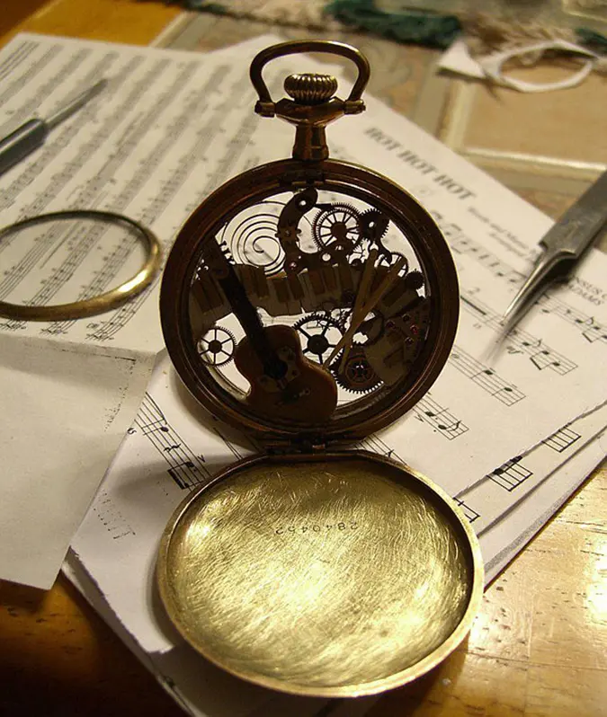 steampunk sculptures musical instruments inside a pocketwatch case