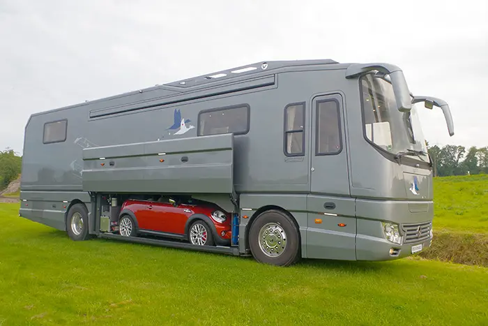 gray luxury motorhome with mini cooper in the built-in garage