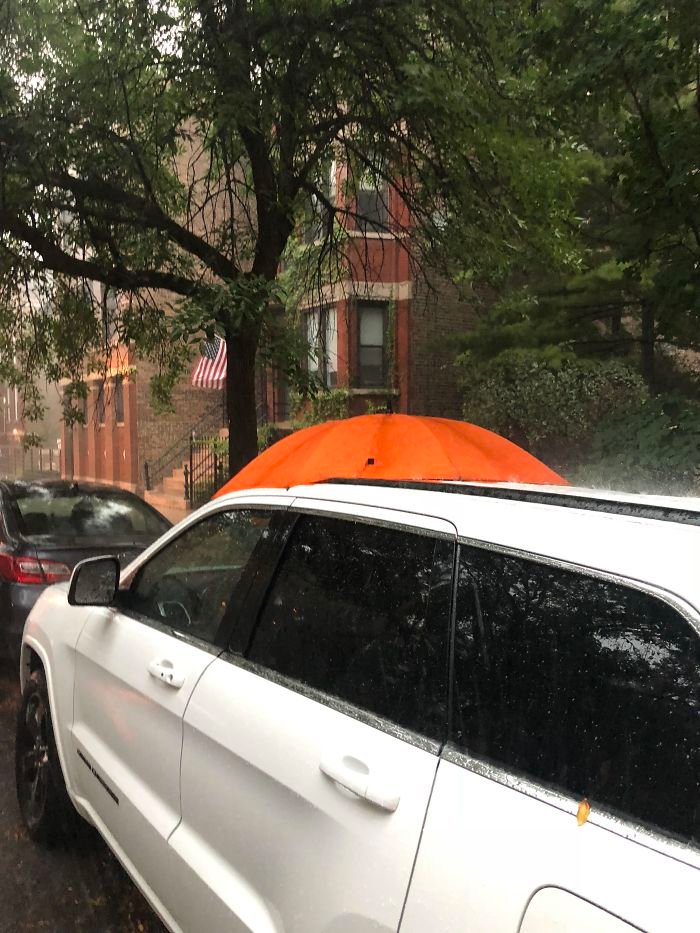 random person covers open sunroof during thunderstorm