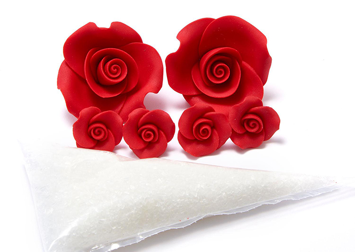 sugar roses and white icing in piping bag