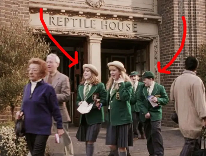 Children in Green Uniforms Walking by the Reptile House